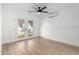 Bright bedroom showcasing a ceiling fan, door to backyard, and paneled accent wall at 2701 E Hobart St, Gilbert, AZ 85296