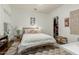 Cozy bedroom with a rattan bed, white walls and light colors at 2701 E Hobart St, Gilbert, AZ 85296