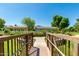 Scenic bridge with a view of lush greenery and charming houses under a clear blue sky at 2701 E Hobart St, Gilbert, AZ 85296