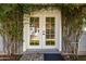 Charming French doors adorned with climbing vines leading to a bright and inviting interior space at 2701 E Hobart St, Gilbert, AZ 85296