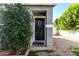 Charming front door surrounded by lush greenery and a brick pathway, creating a warm and inviting entrance at 2701 E Hobart St, Gilbert, AZ 85296