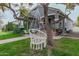 Inviting front porch with hanging chair, stucco walls, and brick steps at 2701 E Hobart St, Gilbert, AZ 85296