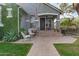 Inviting front porch with hanging chair, stucco walls, and brick steps at 2701 E Hobart St, Gilbert, AZ 85296