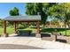 A gazebo with an adjacent grill offers a perfect spot for picnics and outdoor cooking in a serene park setting at 2701 E Hobart St, Gilbert, AZ 85296