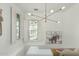 Bright hallway with modern lighting fixture, shuttered windows, and decorative wall art at 2701 E Hobart St, Gilbert, AZ 85296