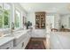 Bright and airy kitchen featuring white cabinets and an antique hutch at 2701 E Hobart St, Gilbert, AZ 85296