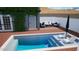 Inviting in-ground pool with built-in loungers and outdoor seating surrounded by beautiful brick pavers and a privacy fence at 2701 E Hobart St, Gilbert, AZ 85296
