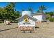 Inviting community with a sign nestled among lush landscaping under a clear blue sky at 2701 E Hobart St, Gilbert, AZ 85296