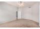 Neutral-toned bedroom with plush carpet, ceiling fan, and access to the hallway at 2704 E Anderson Dr, Phoenix, AZ 85032