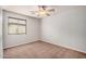 Bedroom featuring neutral walls, carpet, ceiling fan and window with blinds at 2704 E Anderson Dr, Phoenix, AZ 85032