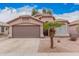 Charming single-story home with a two-car garage and a desert-landscaped yard, complete with a mature palm tree at 2704 E Anderson Dr, Phoenix, AZ 85032