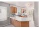 Well-lit kitchen featuring wood cabinets, white countertops, and modern stainless steel appliances at 2704 E Anderson Dr, Phoenix, AZ 85032