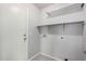 Clean laundry room with shelving, washer hookups, and utility door at 2704 E Anderson Dr, Phoenix, AZ 85032