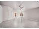 Bright living area with tile flooring, a ceiling fan, neutral-colored walls and access to the rear patio through a glass door at 2704 E Anderson Dr, Phoenix, AZ 85032