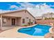 Sparkling in-ground pool with rock features and surrounding patio, perfect for outdoor relaxation and entertainment at 2704 E Anderson Dr, Phoenix, AZ 85032