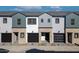 A modern townhome exterior showcasing neutral paint, brick accents, and black garage doors at 2818 W Eagle Talon Rd, Phoenix, AZ 85085