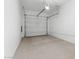 An empty two car garage with concrete floors, a white door, and bright lighting at 2818 W Eagle Talon Rd, Phoenix, AZ 85085