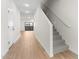 Inviting hallway with wood-look flooring and a staircase with carpet at 2818 W Eagle Talon Rd, Phoenix, AZ 85085