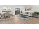 A view of the living area, with the dining area and sliding glass doors offering bright light at 2818 W Eagle Talon Rd, Phoenix, AZ 85085