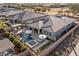 An aerial view of a private backyard with a pool, spa, covered patio, solar panels, and lush landscaping at 30331 N 115Th Ln, Peoria, AZ 85383