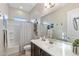 Well-lit bathroom with modern fixtures, a shower-tub combo, and a stylish vanity at 30331 N 115Th Ln, Peoria, AZ 85383