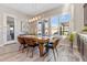 Bright dining room features modern light fixture and a view to the backyard at 30331 N 115Th Ln, Peoria, AZ 85383