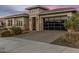 Single-story home featuring stone accents, modern garage doors and desert landscaping in the front yard at 30331 N 115Th Ln, Peoria, AZ 85383