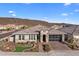 Beautiful single-story home featuring a stone facade, desert landscaping, and a brick driveway at 30331 N 115Th Ln, Peoria, AZ 85383