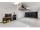 Spacious garage with storage racks, epoxy floors, work bench and black translucent garage doors at 30331 N 115Th Ln, Peoria, AZ 85383