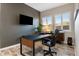 Stylish home office with a modern desk, comfortable chair, and plenty of natural light at 30331 N 115Th Ln, Peoria, AZ 85383