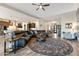 Large living room with hardwood style tile, leather sofa and round area rug at 30331 N 115Th Ln, Peoria, AZ 85383