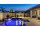 Backyard pool with a water feature and outdoor kitchen with covered seating, perfect for entertaining friends and Gathering at 30331 N 115Th Ln, Peoria, AZ 85383