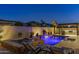 Backyard pool with a water feature and outdoor kitchen with covered seating, perfect for entertaining friends and Gathering at 30331 N 115Th Ln, Peoria, AZ 85383