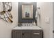 Elegant powder room featuring a unique vanity with marble countertop and modern decor at 30331 N 115Th Ln, Peoria, AZ 85383