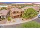 Aerial shot of a two-story home with a well-manicured front yard and a three car garage at 3419 W Thoreau Ln, Anthem, AZ 85086