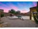 Relaxing backyard with chairs near a waterfall pool and spa, perfect for sunset relaxation at 3419 W Thoreau Ln, Anthem, AZ 85086