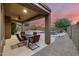 Outdoor dining set on patio with a pool and waterfall in a desert landscape at 3419 W Thoreau Ln, Anthem, AZ 85086