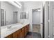 Bright bathroom features a double sink vanity with wood cabinets and a large mirror at 3419 W Thoreau Ln, Anthem, AZ 85086