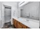 Bathroom featuring a double sink vanity, large mirror, and walk in shower at 3419 W Thoreau Ln, Anthem, AZ 85086