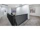 Upstairs hallway with black metal railings, carpeted floors, and lots of natural light at 3419 W Thoreau Ln, Anthem, AZ 85086