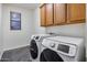 Convenient laundry room with modern, front-loading washer and dryer at 3419 W Thoreau Ln, Anthem, AZ 85086