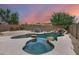 Sparkling pool and spa with rock accents and waterfall feature in a serene backyard setting at 3419 W Thoreau Ln, Anthem, AZ 85086