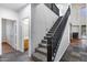 Carpeted staircase with black railings connects the levels, leading to a partially visible bathroom at 3419 W Thoreau Ln, Anthem, AZ 85086