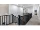 Upper hallway featuring a staircase with black railings and neutral carpeting at 3419 W Thoreau Ln, Anthem, AZ 85086