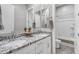 Bright bathroom with double sinks and a granite countertop, complemented by white cabinets and a shower-tub combination at 3504 E Boot Track Trl, Gilbert, AZ 85296