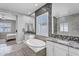 Luxurious bathroom features a soaking tub, dual vanities, and elegant tile work at 3504 E Boot Track Trl, Gilbert, AZ 85296