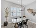 Bright dining room with modern light fixture, large window, and decorative wall hangings at 3504 E Boot Track Trl, Gilbert, AZ 85296