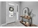 Light and airy foyer showcasing a stylish console table and a decorated front door at 3504 E Boot Track Trl, Gilbert, AZ 85296