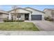 Charming single-story home featuring a well-manicured lawn and stone accents at 3504 E Boot Track Trl, Gilbert, AZ 85296