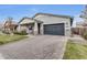 Attractive single-story home with a gray garage door and a spacious brick driveway at 3504 E Boot Track Trl, Gilbert, AZ 85296